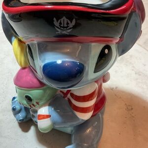 Disney Pirate Stitch Animal Mug, Blue, Red, & Green holding a dressed up Scrump.